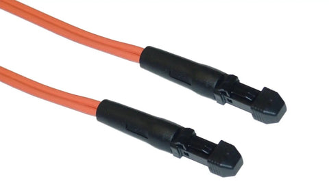 Close-up of two black connectors on orange cables for electronic equipment.