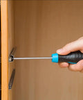 Hand using screwdriver to install 6x14mm short expansion screws for cabinet hinge repair and stripped thread restoration kit.