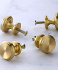 4 Piece Mid Century Modern Solid Brass Cabinet Knob Set for Drawers with 25mm Screws on marble surface