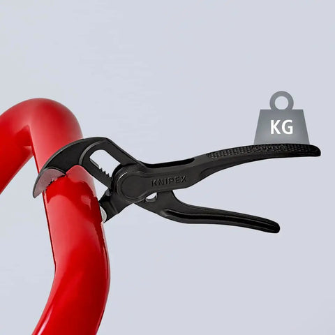Cobra XS Pipe Wrench and Water Pump Pliers gripping red pipe, slim head design, 100 mm atramentized embossed surface visible
