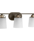 West Village Bath And Vanity Light Fixture In Antique Bronze, Modern Industrial Style, three prismatic glass lights, wall-mounted