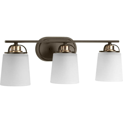 West Village Bath And Vanity Light Fixture In Antique Bronze, Modern Industrial Style, three prismatic glass lights, wall-mounted