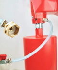 Close-up view of brass hose adapter with blue braided hose on a red core drill unit