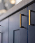 Set Of 6 Cabinet Pulls 3 Inch Center To Center Antique Brass Finish installed on blue cabinet door