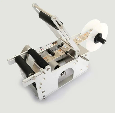 Heavy Duty Semi Auto Round Bottle Labeler For 15 To 120 Mm Containers Runs Like Clockwork At Forty Labels Per Minute featuring a smooth feed reel.