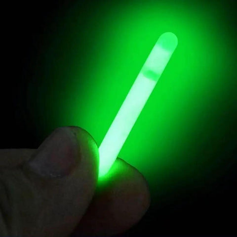 A hand holding a glowing light stick from 100 Pack Ultra Pro Grade Slim 3Mm Fluorescent Glow Light Sticks For Night Fishing Floats Corks And Terminal Tackle Accessories To Brighten Low Light Waters In Dark Waters
