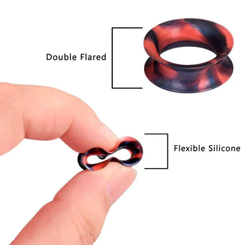 Close-up of colorful silicone ear gauge plug, double flared, held between fingers, emphasizing flexibility for everyday wear.