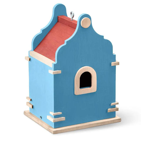 Blue wooden decorative birdhouse with red roof, featuring a small entry hole, suitable for outdoor garden decor.