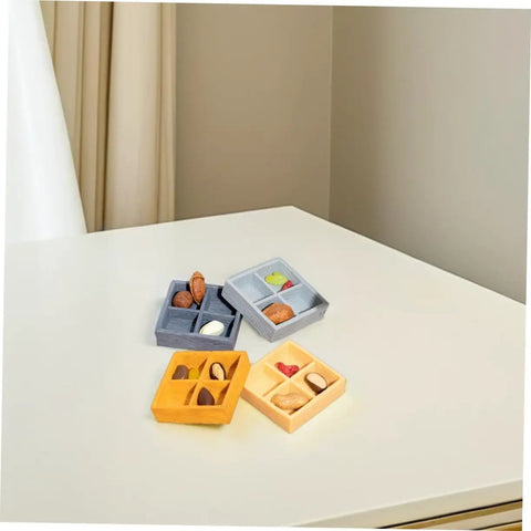 Four Grid Dollhouse Storage Box Resin Organizer For Candy, Nuts, And Sweet Tiny Treats on a table, various colors with nuts and candies.