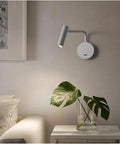 Wall Sconce Modern Indoor LED Adjustable Bedside Lamp Nordic Reading Infinite Indoor Bedroom Reading Light(White) mounted beside plant.