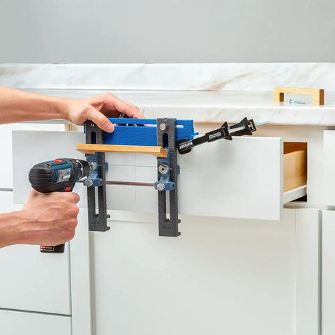 Person using Cabinet Hardware Jig And Pull Drill Guide Pro For Easy Install on kitchen drawer for precise handle alignment