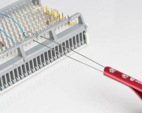 Jonard Tools Jic-2257M Metal Wire Loop Puller With Red Anodized Aluminum Handle, 8-1/2" Length extracting wires from a terminal block.