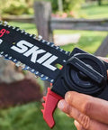 Close-up of 8 inch SKIL chainsaw bar with handle, showcasing Solid Build Cordless Pole Saw With Eight Inch Bar And Ten Foot Reach To Clear High Limbs Like A Pro 20V Lithium Motor.
