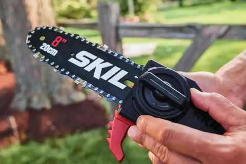 Close-up of 8 inch SKIL chainsaw bar with handle, showcasing Solid Build Cordless Pole Saw With Eight Inch Bar And Ten Foot Reach To Clear High Limbs Like A Pro 20V Lithium Motor.