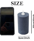 Six Pack Large 4 By 2 Inch Round Air Stones For Aquarium And Hydroponics, Heavy Duty Bubble Diffuser next to phone for size comparison