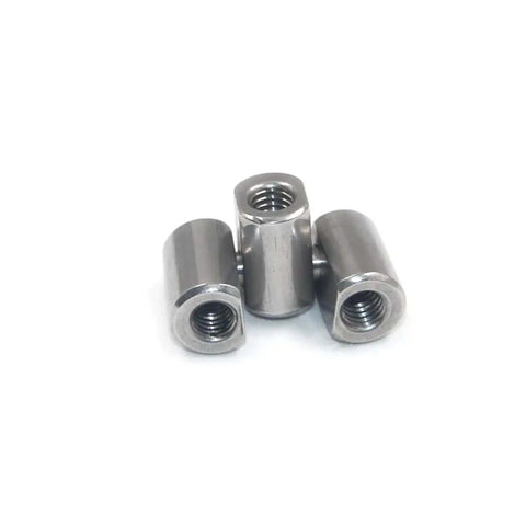 Three metal hexagonal nuts arranged upright on a white background, showcasing threaded interiors and hexagonal exteriors.