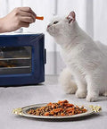 Digital Electric Food Dehydrator With Four Stackable Stainless Steel Trays And Precision Temperature Controls Featuring A Rock Solid Forty Eight Hour Timer For Sick Fast Jerky Fruit Veggie And Herb Preservation next to cat being fed.