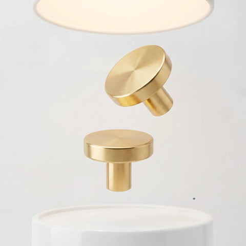 Close-up of two floating knobs from Gold Metal Cabinet Knobs 10 Pack - Round Drawer Pulls For Dressers, Cabinets in brushed finish.
