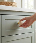 Hand installing Beige Travertine Square Cabinet Knob Set Of 6 With Screws on a gray dresser