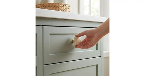 Hand installing Beige Travertine Square Cabinet Knob Set Of 6 With Screws on a gray dresser