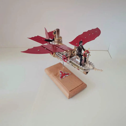 Stirling Air Ship Model Kit for Steampunk Fans DIY Metal Flying Machine with red wings and combustion engine on wooden base