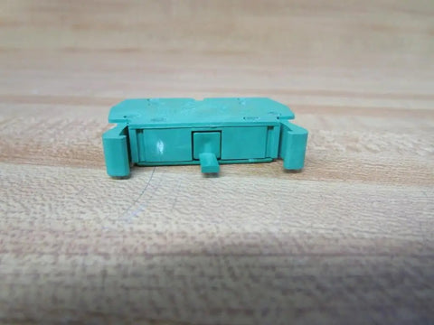 Heavy Duty Green Normally Open Contact Block Wno For 22Mm Pilot Devices With 10 Amp And 600 Vac Rating side view on a wooden surface.