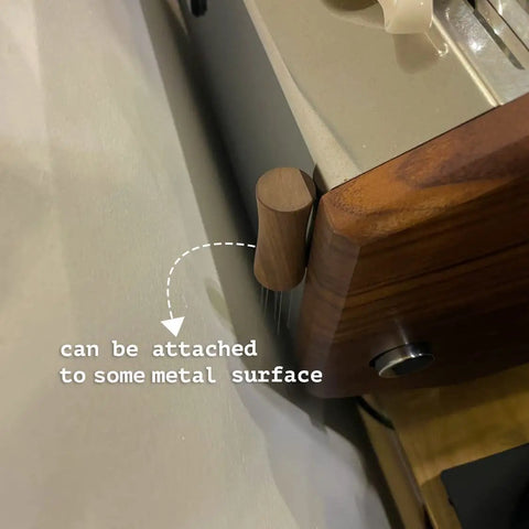 Espresso WDT Tool V2.0 with built-in magnet and stand attached to metal surface, showcasing walnut wood distribution for even extraction.