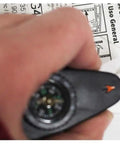 Close-up of 4 In 1 Outdoor Survival Tool With Whistle, Compass, Magnifier And Thermometer Plus Key Ring held in hand