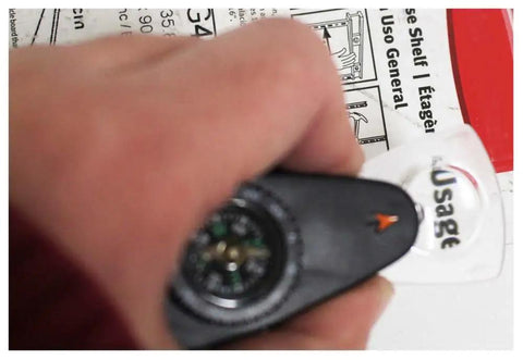 Close-up of 4 In 1 Outdoor Survival Tool With Whistle, Compass, Magnifier And Thermometer Plus Key Ring held in hand