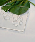 Badass Double Paw Print Router Template For Heavy Duty Woodworking Resin Inlay Cavities Clear Quarter Inch Acrylic Stencil Tracing Guide on green leaves.
