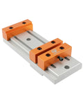 Compact Aluminum Alloy Bench Vise Featuring Slick Low Profile Build Dead Simple Setup Rock Solid Grip For CNC Engraving Machines with orange jaws and silver base.