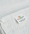 Close-up of White Shop Towels B Grade Rags 60 Pcs 20x40 Inches in a Box for industrial and commercial use showing fabric label.