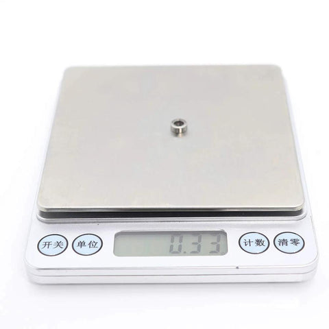 Miniature metal shielded ball bearing L-740ZZ on digital scale; 4x7x2.5 mm ABEC-5.