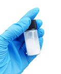 Gloved hand holding a vial of Boron Nitride Nanotubes BNNTs Top Shelf Lab Grade White Nano Powder 60 Nanometer Diameter And 0.1 To 20 Micron Length Great For Radiation Shielding Optoelectronics Heat Dissipation And Nanosensor Applications.