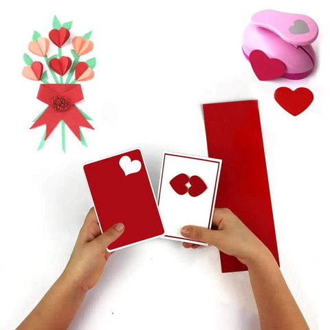 Child using 4 Pack Paper Punches Set 1 Inch Shapes Round Star Heart Flower for Scrapbooking DIY crafts with heart shapes.