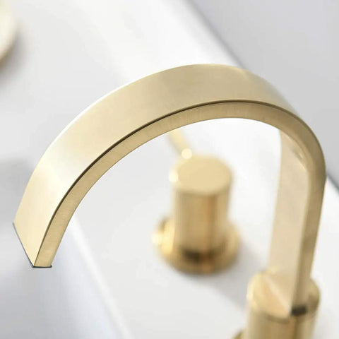 Close-up of Two Handles 8 Inch Widespread Bathroom Faucet In Brushed Gold Finish With Valve And Metal Pop Up Drain Three Hole Mount Eight Inch Center Spread Sleek Modern Diy Bathroom Upgrade faucet spout.