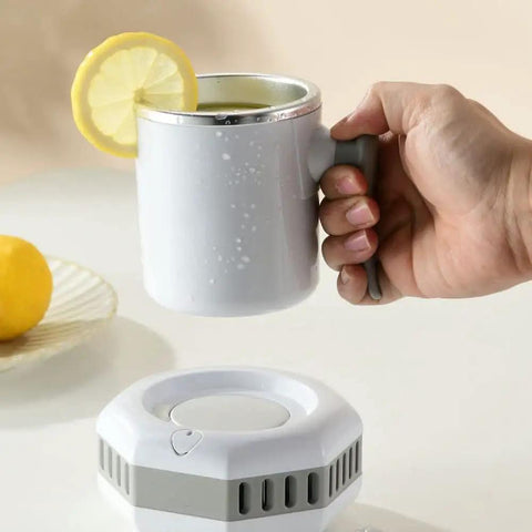 Portable Electric Mini Fridge Cooler For Desk And Ride Keeps Your Beverages Frosty On The Daily With Rapid Chill Function showing a person holding a chilled cup with lemon.