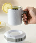 Electric Beverage Cooler Jug With Instant Cooling Cup And Mug Mini Fridge, hand holding mug with lemon slice.