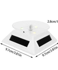 Xhtllo Electric Led Light Solar Powered Rotating Turntable Display Stand For Jewelry Phunique Watches Camera And Decorations with triangular base design.