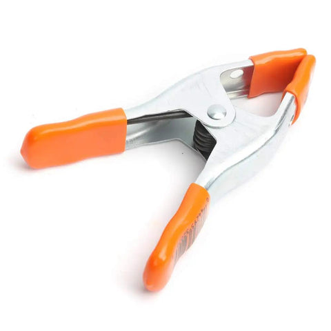 2 Inch Spring Clamp With Handle One Handed Clamping Tool Silver Orange Finish Quick Release Paddle Action for Woodworking and DIY Projects Workhorse Grip Control, close-up view.