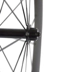 Close-up on hub and spokes of Carbon 700c Clincher Wheelset For Road Bikes, 23mm Rim Width, Toray T700 Carbon Fiber Build.