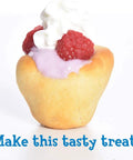 Cup-shaped pastry filled with pink cream, topped with raspberries and whipped cream.