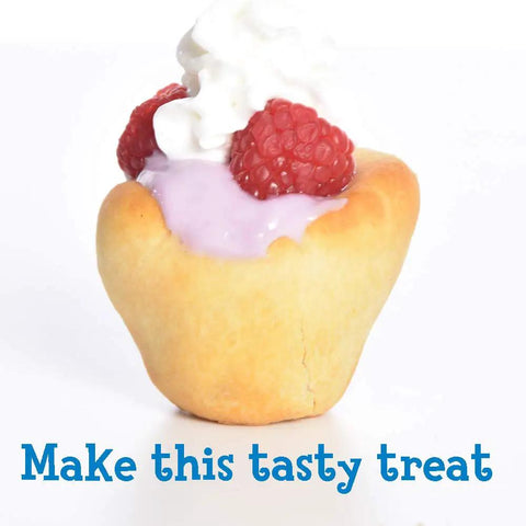 Cup-shaped pastry filled with pink cream, topped with raspberries and whipped cream.