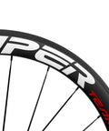 Close-up of 50mm Carbon Clincher Wheelset For Road Racing 700c With 23mm Width Toray T700 Matte 3K Finish UCI Approved White And Red Decals