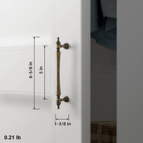 Side view of Six Pack 5 Inch Antique Brass Cabinet Pull with ornate tapered handles and decorative finials installed on white cabinet.