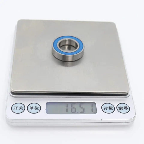 Ten Pack 6903 RS Ball Bearings 17x30x7mm ABEC-3 Shielded 2RS shown on a digital scale measuring 16.57 grams