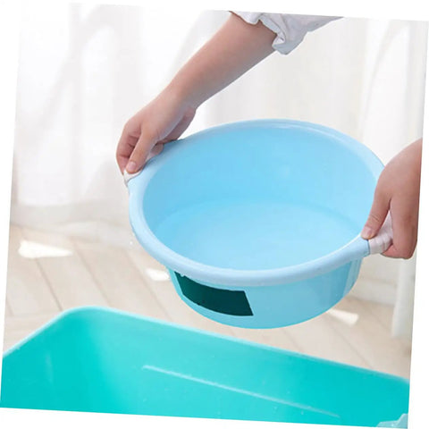 Person holding a light blue plastic basin above a sink area