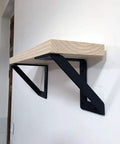 Heavy Hitter Iron Corner Brackets For Floating Shelves Built Tough Right Angle Wall Support Takes A Beating Holds Up To 176 Pounds Pair Of Two Matte Black on wall with wood shelf.