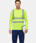 Model wearing Shop Floor Ready Long Sleeve Hi Vis Safety Shirt With Bold Reflective Strips Class Three Ansi Certified Work Tee in yellow.
