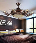 Invisible Retractable Ceiling Fan With Adjustable Dual Tone LED Lighting Plus Hassle Free Remote Control For Ultra Quiet Living Room Kitchen Vibe Upgrade in decorative bronze finish above a stylish bedroom.